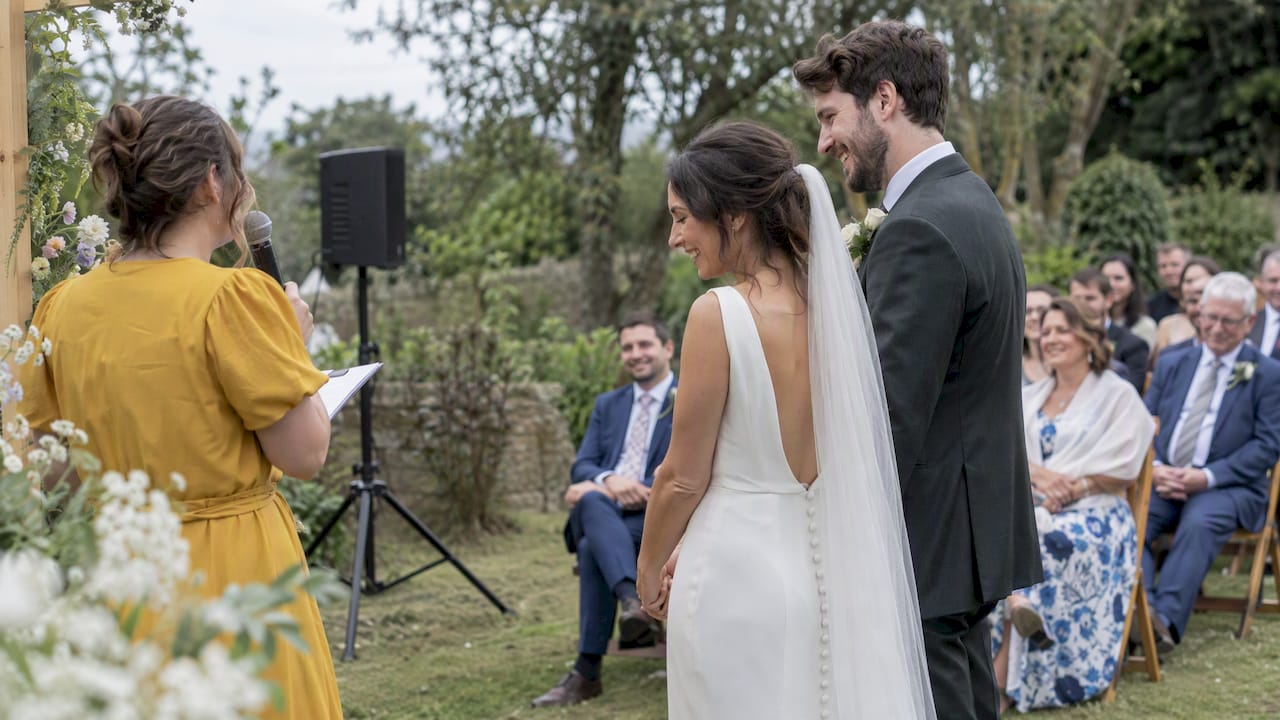 Bride and groom smiling during their ceremony