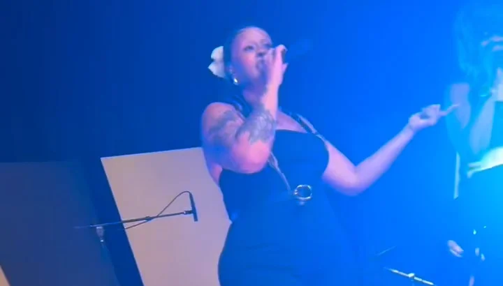 Lost Wax vocalist singing under blue stage lights at the Nebraska Wedding Day Best of 2026 Awards Gala at The Leo Ballroom in Omaha, NE on June 16, 2026
